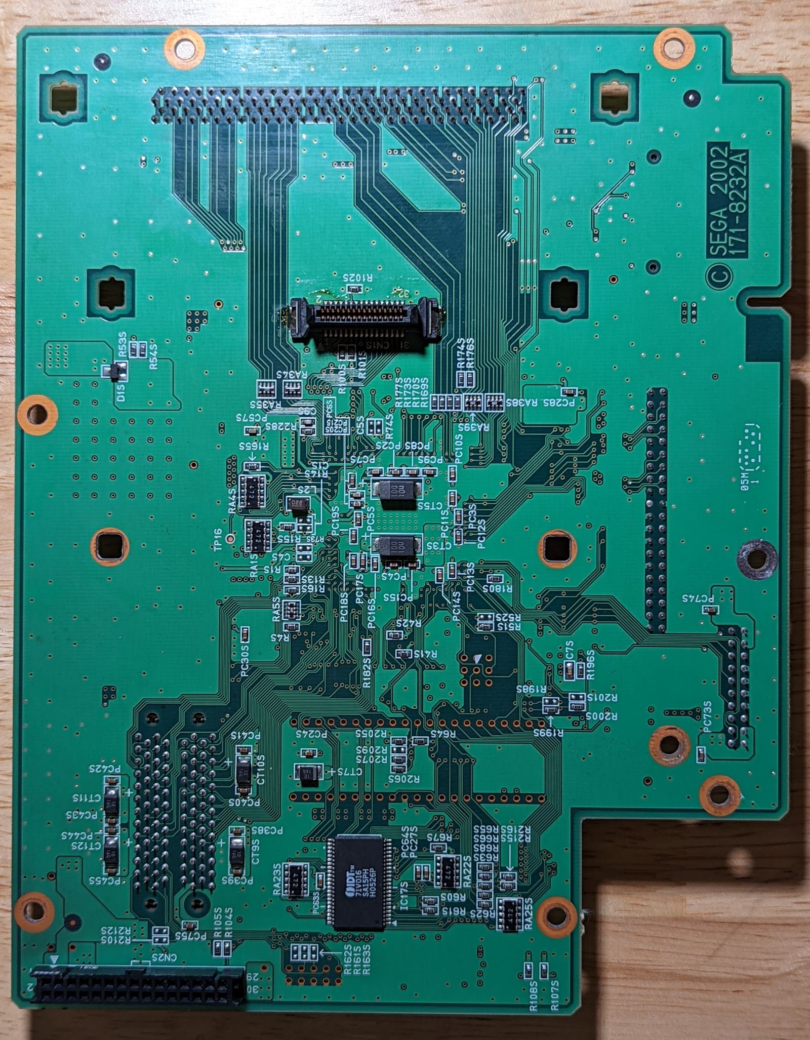 Photo of Triforce media board, bottom view. There's a connector which fits into the GameCube DVD interface port on the bottom.