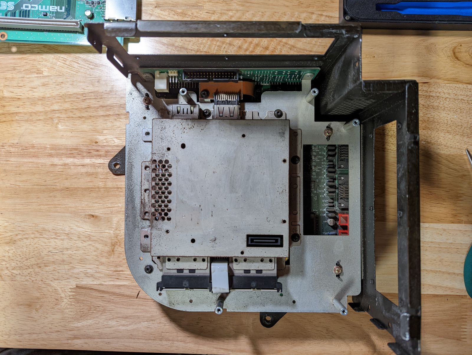 Photo of Triforce interior, top view, with the media board removed. Mostly metal shielding is visible.