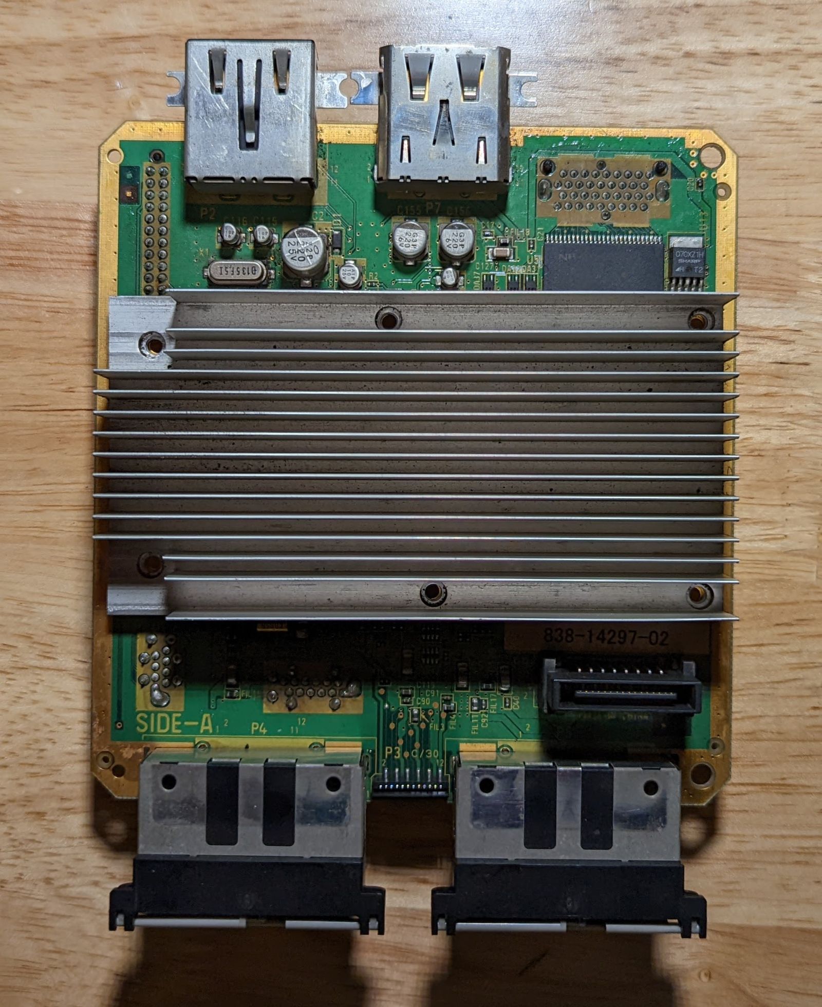 Photo of Triforce main board, a DOL-001, top view. Labeled 'Side-A'. The heat sink is still attached, covering most of the board.