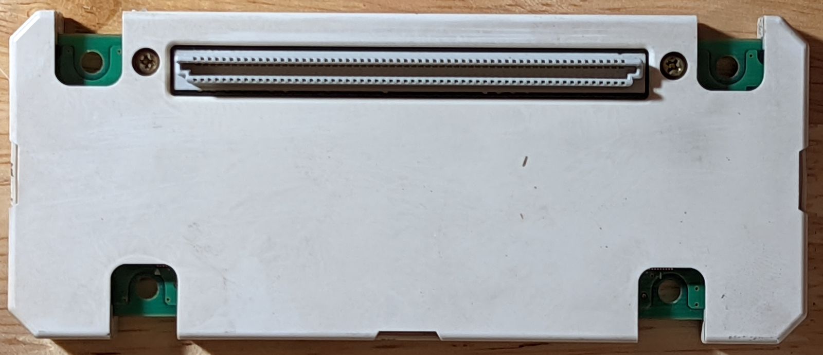 Photo of Triforce Type 3 NAND cartridge exterior, bottom view. 120-pin female connector of some sort is visible.